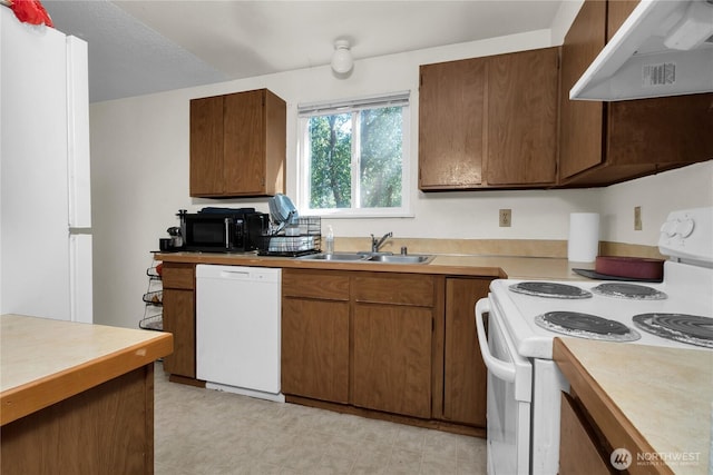 8024 N Bicentennial Loop SE, Lacey, WA 98503 - kitchen featuring white appliances, under cabinet range hood, a sink, and light countertops