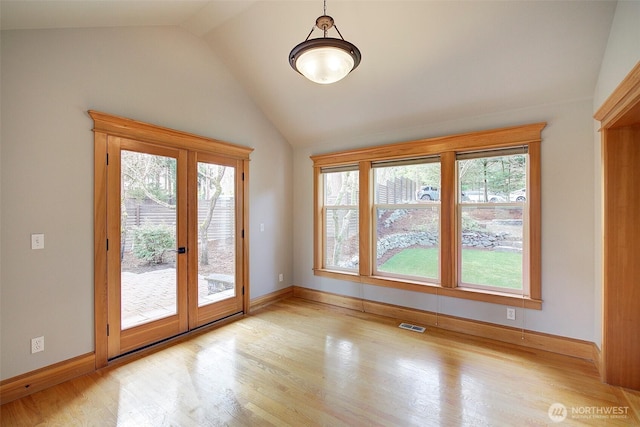 23623 20th Ave W, Bothell, WA 98021 - doorway to outside with french doors, healthy amount of natural light, vaulted ceiling, wood finished floors, and baseboards