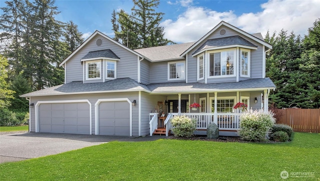 19609 95th Avenue Ct E, Graham, WA 98338 - victorian home featuring a porch, an attached garage, driveway, and roof with shingles