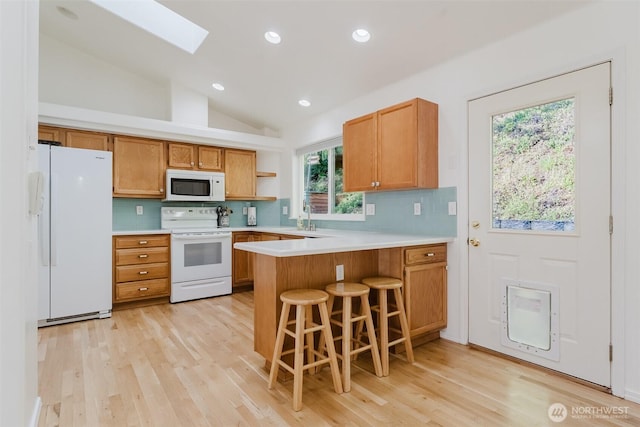 4 Alder Ct, Bellingham, WA 98229 - kitchen featuring white appliances, a peninsula, light countertops, tasteful backsplash, and lofted ceiling