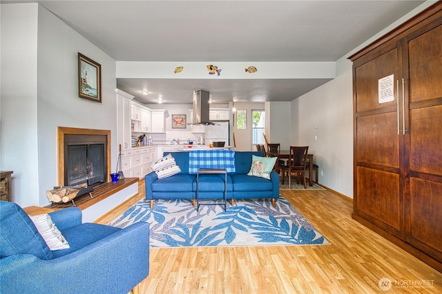 7806 Birch Bay Dr Unit 1007, Blaine, WA 98230 - living room featuring light wood-type flooring and a fireplace with raised hearth