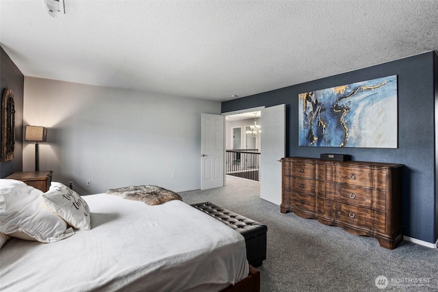 176 Raspberry Ln, Woodland, WA 98674 - carpeted bedroom featuring a chandelier, a textured ceiling, and baseboards
