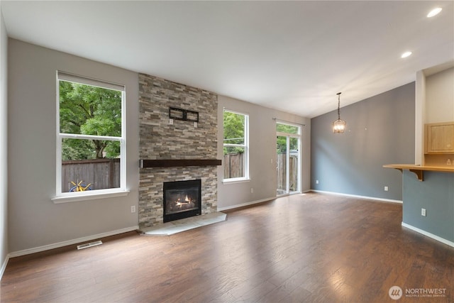 2538 Hidden Springs Loop SE, Olympia, WA 98503 - unfurnished living room featuring wood finished floors, a stone fireplace, vaulted ceiling, baseboards, and recessed lighting