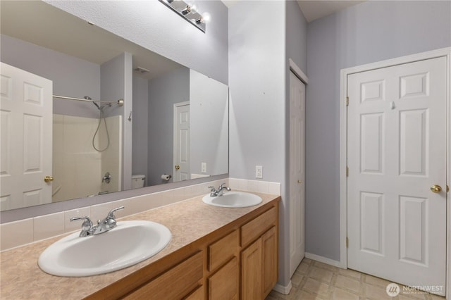 2538 Hidden Springs Loop SE, Olympia, WA 98503 - full bath featuring double vanity, toilet, and baseboards