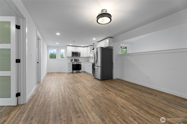 7409 Myers Rd, Bonney Lake, WA 98391 - unfurnished living room with wood finished floors and recessed lighting
