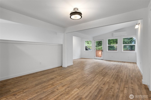 7409 Myers Rd, Bonney Lake, WA 98391 - spare room with an AC wall unit, wood finished floors, and lofted ceiling