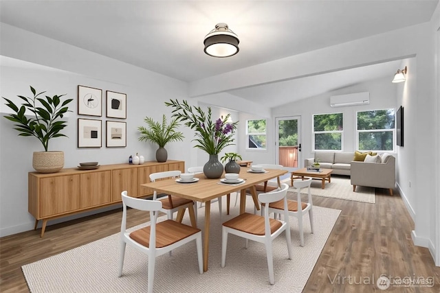 7409 Myers Rd, Bonney Lake, WA 98391 - dining space with a wall unit AC, lofted ceiling, and wood finished floors