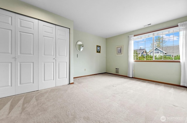 3238 NE 100th St Unit D, Seattle, WA 98125 - unfurnished bedroom featuring carpet floors, baseboards, and a closet