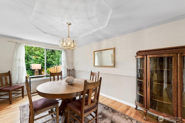 3238 NE 100th St Unit D, Seattle, WA 98125 - dining space with a chandelier, light wood-style floors, crown molding, and baseboards