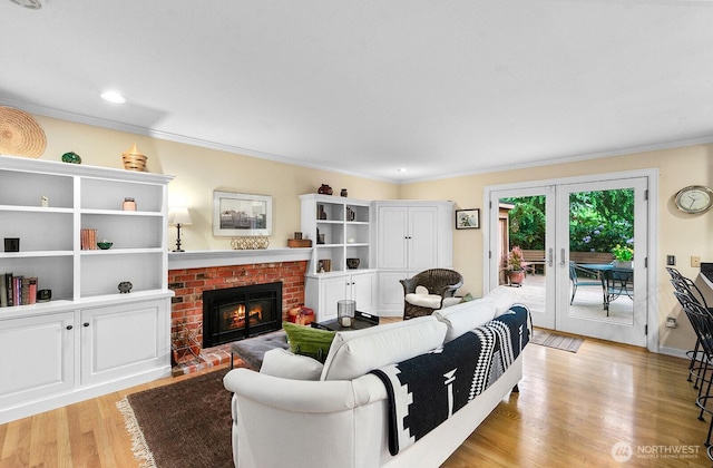 3238 NE 100th St Unit D, Seattle, WA 98125 - living room with a fireplace, crown molding, light wood-style flooring, and french doors