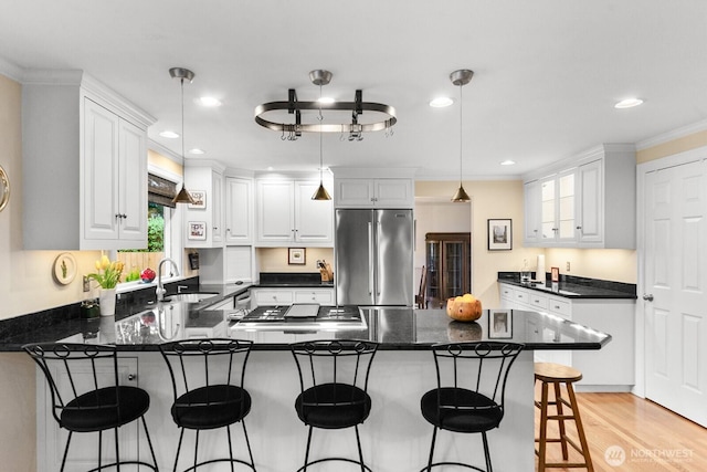 3238 NE 100th St Unit D, Seattle, WA 98125 - kitchen featuring appliances with stainless steel finishes, a peninsula, a sink, white cabinetry, and recessed lighting