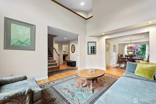 3238 NE 100th St Unit D, Seattle, WA 98125 - living room featuring light wood-style flooring, stairs, baseboards, a chandelier, and recessed lighting