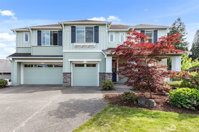 10815 NE 190th Pl, Bothell, WA 98011 - view of front facade with a garage, board and batten siding, driveway, and stone siding