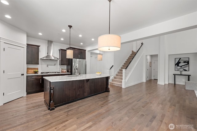 10815 NE 190th Pl, Bothell, WA 98011 - kitchen featuring wall chimney exhaust hood, high end refrigerator, dark brown cabinets, a sink, and recessed lighting