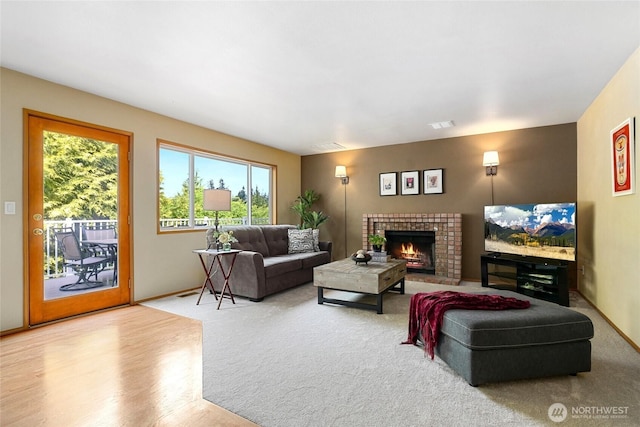 13218 42nd Ave W, Mukilteo, WA 98275 - living area with a brick fireplace, baseboards, and wood finished floors