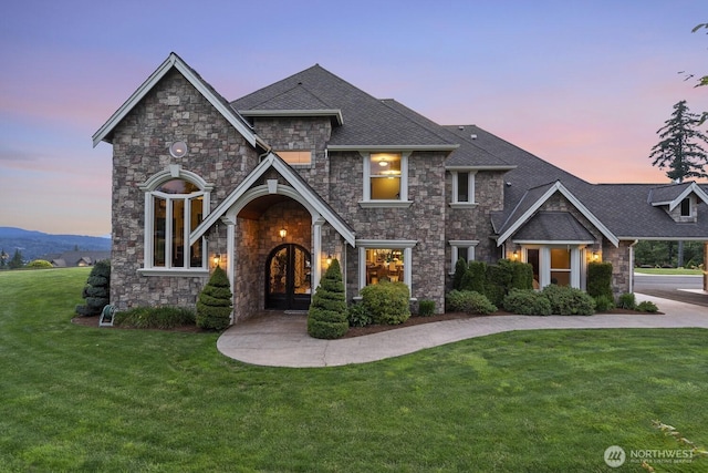 1844 Vineyard Pl, Bellingham, WA 98226 - view of front of home featuring stone siding, a lawn, french doors, and roof with shingles