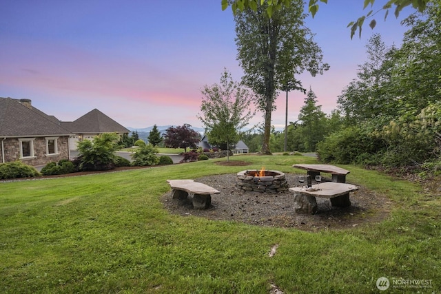 1844 Vineyard Pl, Bellingham, WA 98226 - yard at dusk with an outdoor fire pit and a lawn