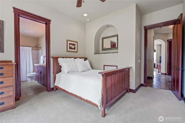 1844 Vineyard Pl, Bellingham, WA 98226 - bedroom featuring light carpet, arched walkways, connected bathroom, ceiling fan, and baseboards