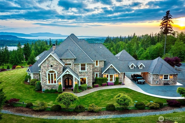 1844 Vineyard Pl, Bellingham, WA 98226 - view of front of house featuring stone siding, a chimney, and a front yard