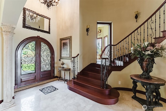 1844 Vineyard Pl, Bellingham, WA 98226 - entrance foyer featuring a towering ceiling, decorative columns, stairs, baseboards, and french doors