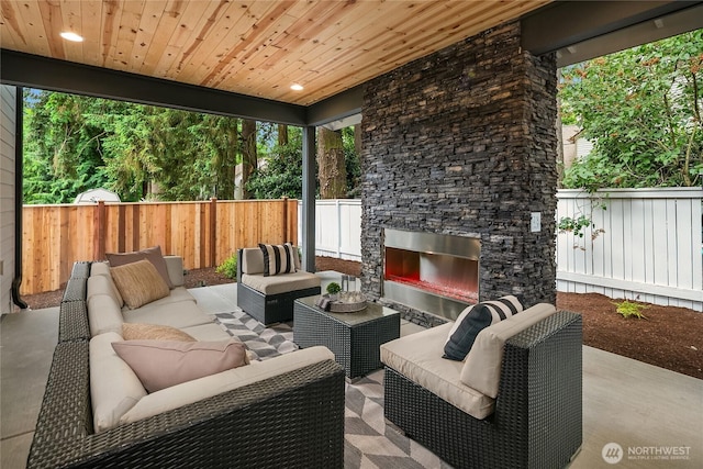 10207 NE 136th Pl, Lot, Kirkland, WA 98034 - fenced backyard featuring an outdoor living space with a fireplace and a patio area