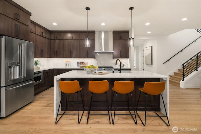 10207 NE 136th Pl, Lot, Kirkland, WA 98034 - kitchen featuring high quality fridge, wall chimney range hood, light wood-style flooring, dark brown cabinetry, and recessed lighting