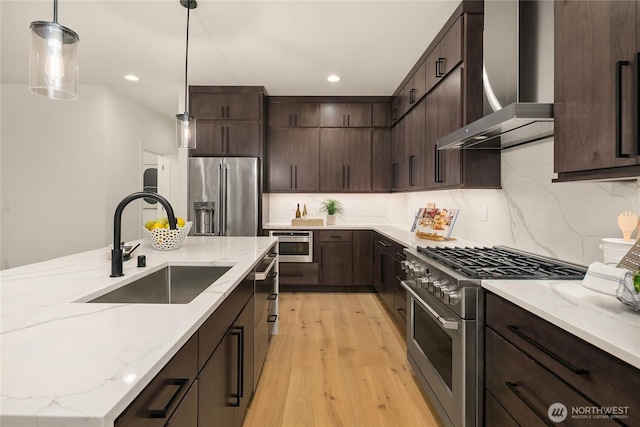10207 NE 136th Pl, Lot, Kirkland, WA 98034 - kitchen with high quality appliances, wall chimney exhaust hood, dark brown cabinetry, light wood-style floors, and recessed lighting