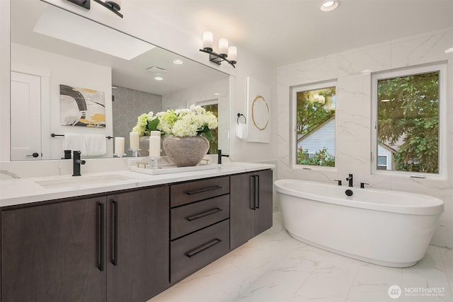 10207 NE 136th Pl, Lot, Kirkland, WA 98034 - full bath featuring double vanity, marble finish floors, plenty of natural light, tile walls, and recessed lighting