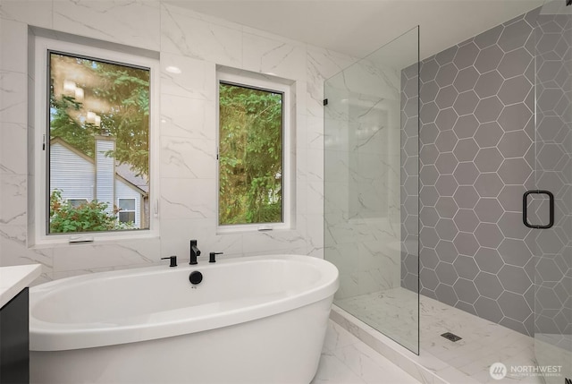 10207 NE 136th Pl, Lot, Kirkland, WA 98034 - bathroom with marble look tile flooring, tile walls, healthy amount of natural light, a freestanding bath, and a stall shower