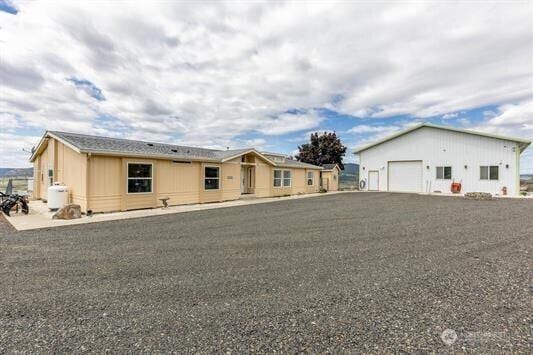 30350 Deer Meadows Rd E, Deer Meadows, WA 99122 - view of front facade featuring a garage and an outbuilding