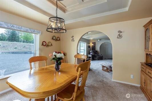30350 Deer Meadows Rd E, Deer Meadows, WA 99122 - dining area with arched walkways, light carpet, a chandelier, and baseboards