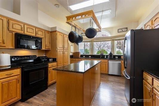 30350 Deer Meadows Rd E, Deer Meadows, WA 99122 - kitchen with black appliances, dark wood-style floors, a kitchen island, and a sink