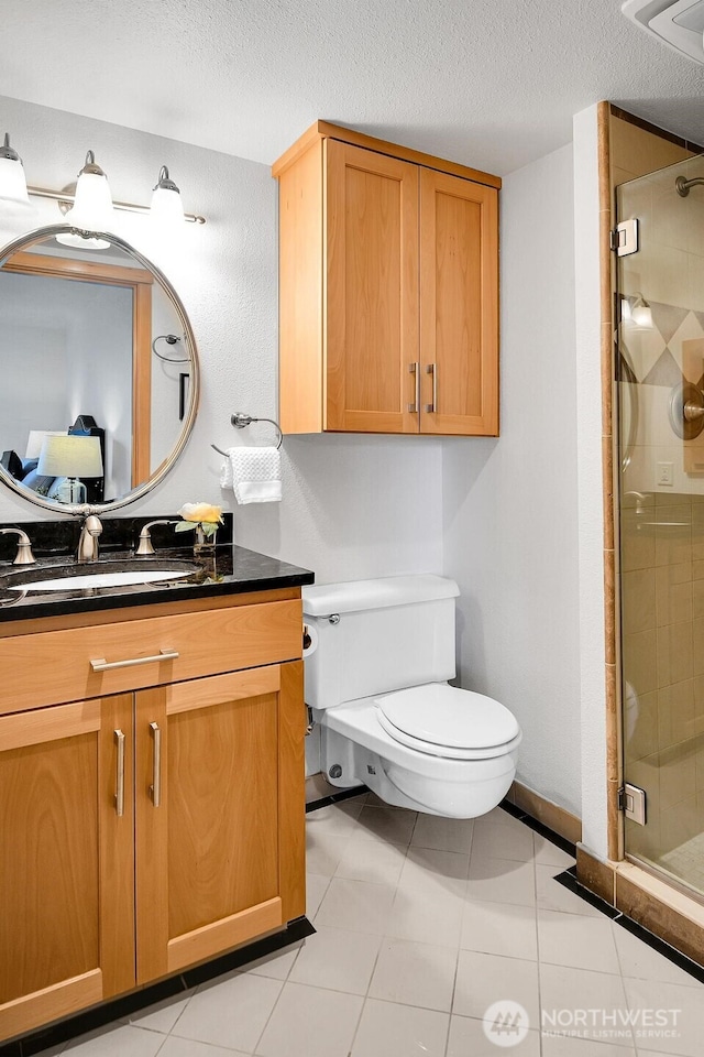 1605 5th Ave N Unit 402, Seattle, WA 98109 - bathroom with toilet, a stall shower, vanity, a textured ceiling, and tile patterned floors