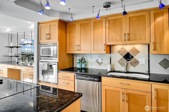 1605 5th Ave N Unit 402, Seattle, WA 98109 - kitchen featuring appliances with stainless steel finishes, a sink, dark stone counters, and backsplash