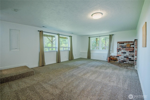 491 N Suncrest Dr, Hoodsport, WA 98548 - empty room featuring plenty of natural light, a textured ceiling, carpet flooring, electric panel, and baseboards