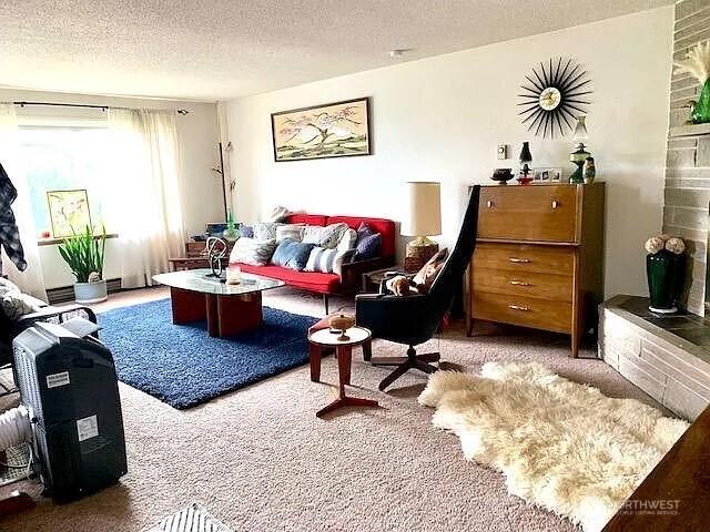 1417 N 7th St, Tacoma, WA 98403 - living area with carpet flooring, a textured ceiling, and a wall mounted AC