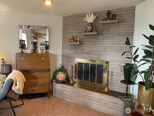 1417 N 7th St, Tacoma, WA 98403 - carpeted living area featuring a fireplace and a textured ceiling