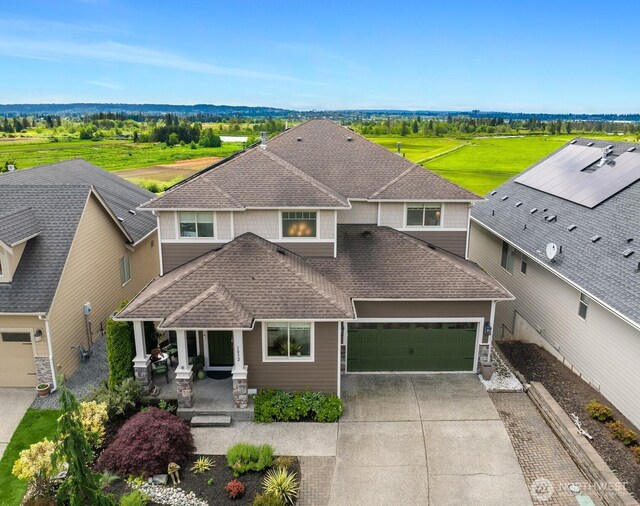 1032 76th Ave NE, Lake Stevens, WA 98258 - view of front of house featuring roof with shingles, concrete driveway, a porch, and an attached garage
