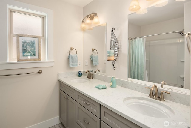 1032 76th Ave NE, Lake Stevens, WA 98258 - full bathroom with double vanity, a shower with shower curtain, and baseboards