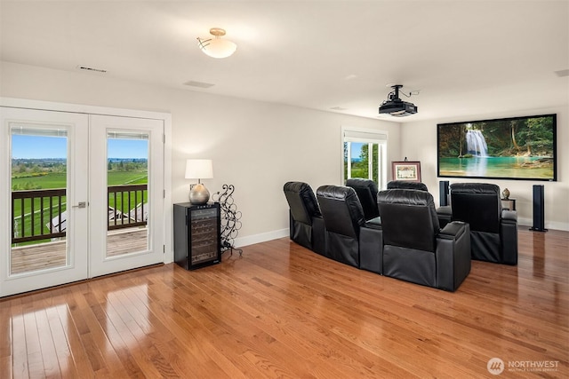 1032 76th Ave NE, Lake Stevens, WA 98258 - home theater featuring french doors, beverage cooler, light wood-style floors, and baseboards