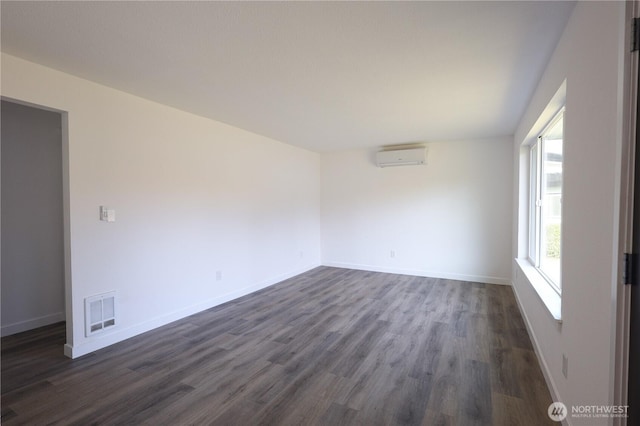 814 5th St Unit 8143, Steilacoom, WA 98388 - spare room featuring dark wood finished floors, an AC wall unit, and baseboards