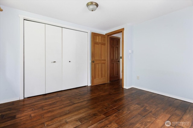 5092 Ribbit Rd, Langley, WA 98260 - unfurnished bedroom with dark wood finished floors, a closet, and baseboards