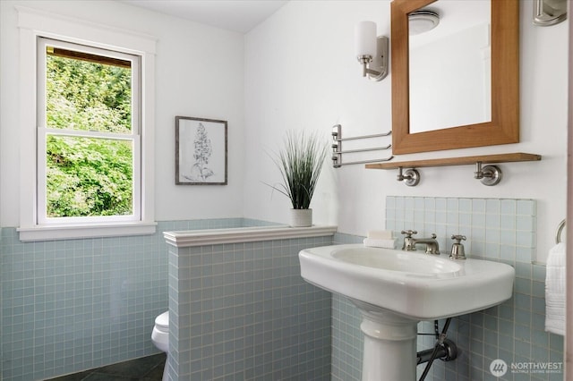 5092 Ribbit Rd, Langley, WA 98260 - bathroom with tile walls, wainscoting, toilet, and tile patterned flooring