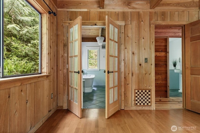 5092 Ribbit Rd, Langley, WA 98260 - doorway to outside featuring french doors, wooden walls, wood finished floors, and beam ceiling