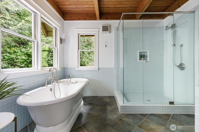 5092 Ribbit Rd, Langley, WA 98260 - bathroom featuring wood ceiling with exposed beams, tile walls, a stall shower, a freestanding bath, and a wainscoted wall
