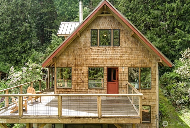5092 Ribbit Rd, Langley, WA 98260 - rustic home with a forest view, a wooden deck, a standing seam roof, and metal roof