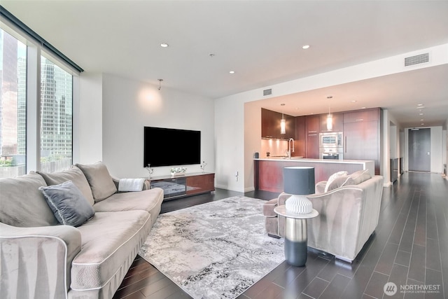 10700 NE 4th St Unit 1006, Bellevue, WA 98004 - living room with dark wood finished floors and recessed lighting