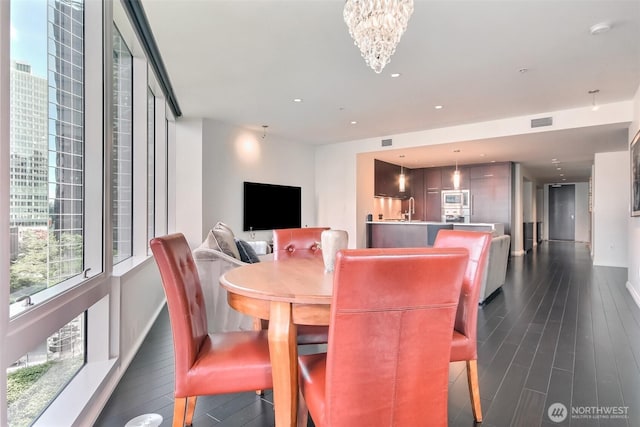10700 NE 4th St Unit 1006, Bellevue, WA 98004 - dining room with a chandelier, dark wood-style floors, recessed lighting, and baseboards