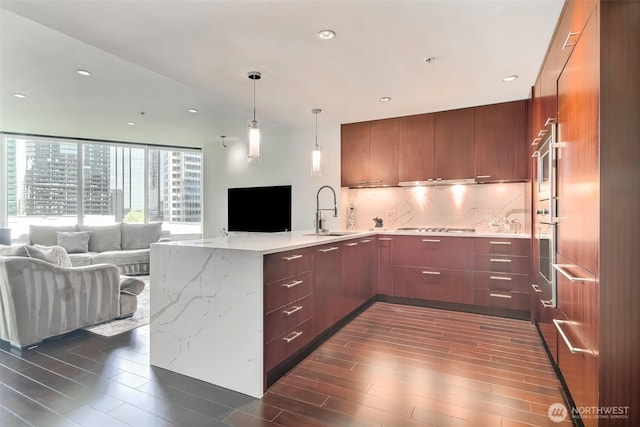 10700 NE 4th St Unit 1006, Bellevue, WA 98004 - kitchen featuring a sink, open floor plan, a peninsula, modern cabinets, and recessed lighting
