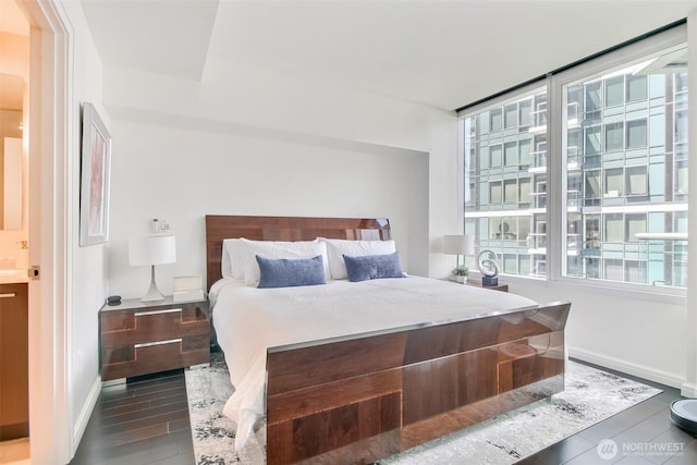 10700 NE 4th St Unit 1006, Bellevue, WA 98004 - bedroom with baseboards and dark wood-style floors